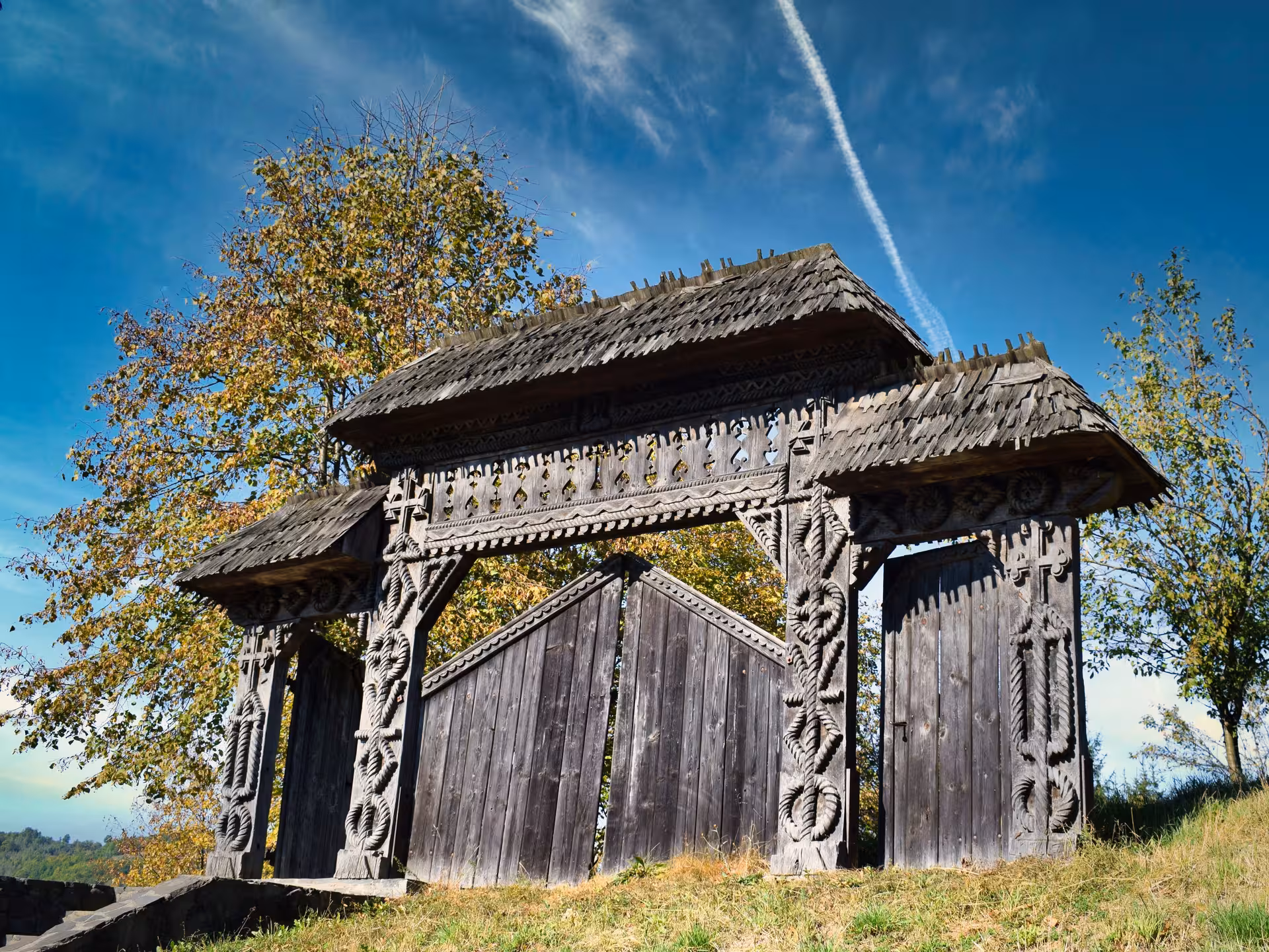 Traditional hand-carved wooden gate of a Maramures rural village Romania showcasing authentic folk art on a guided tour
