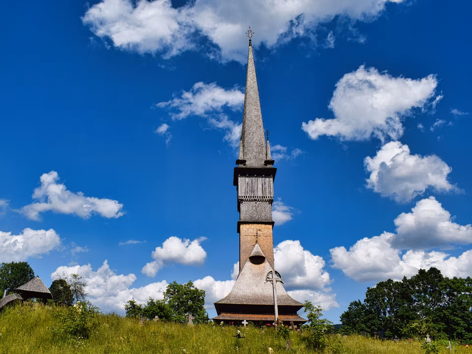 Iconic UNESCO wooden church with tall spire in Maramures Romania on a 3-day guided tour from Cluj