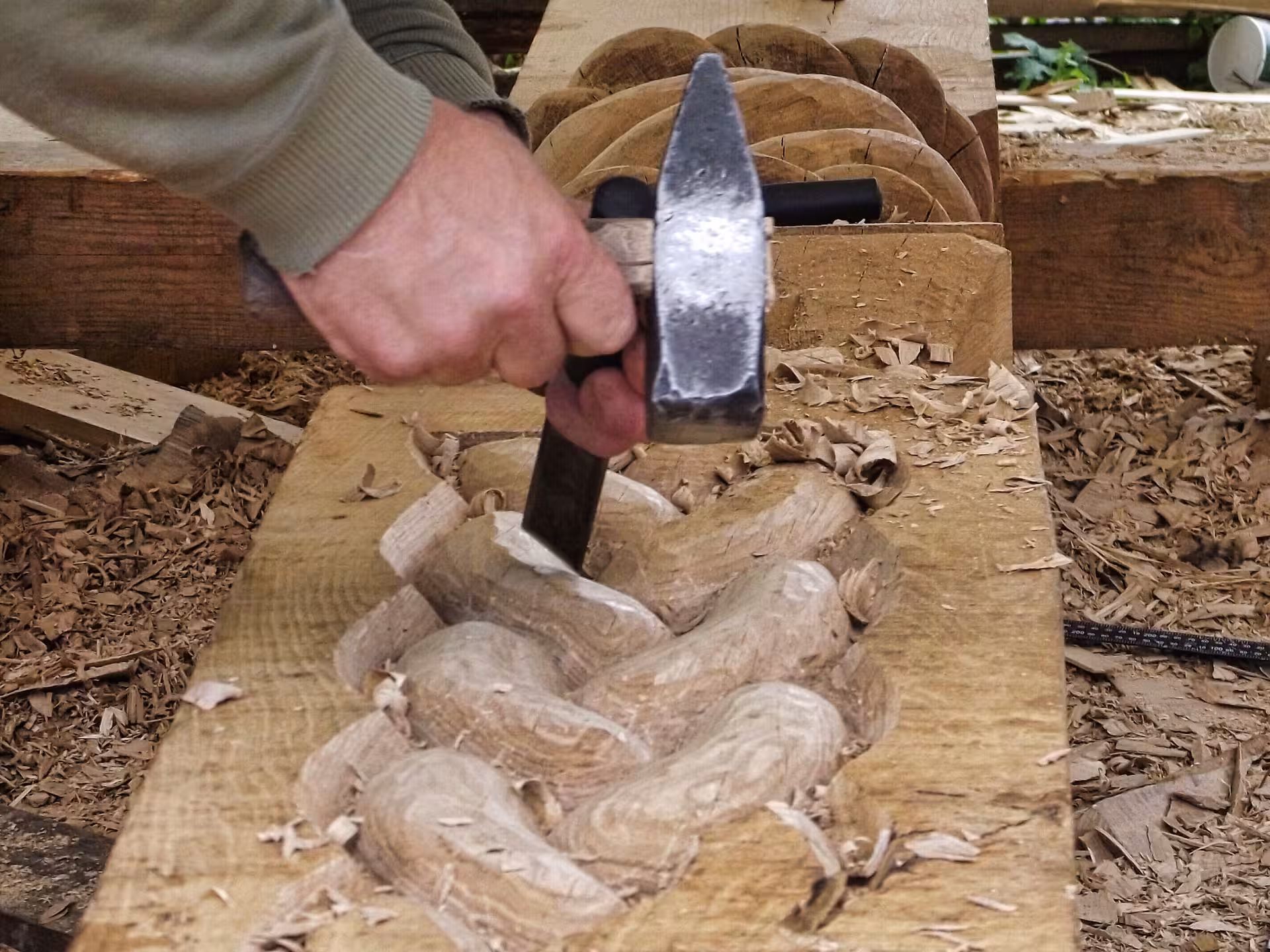 Skilled craftsman hand-carving intricate wood patterns during a Maramures cultural tour from Cluj Romania