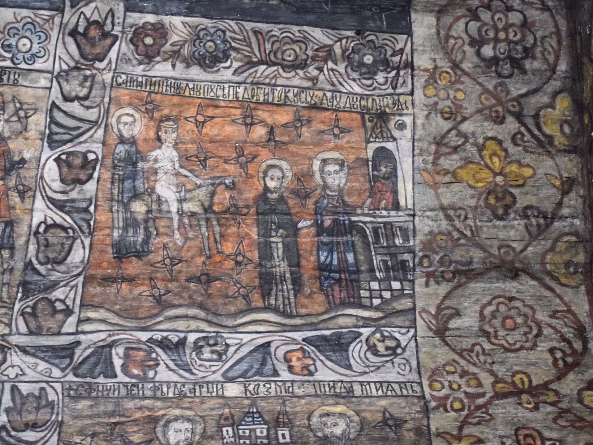 Ancient hand-painted biblical fresco with Cyrillic inscriptions inside a historic wooden church on a Maramures Bucovina 3-day tour from Cluj Romania