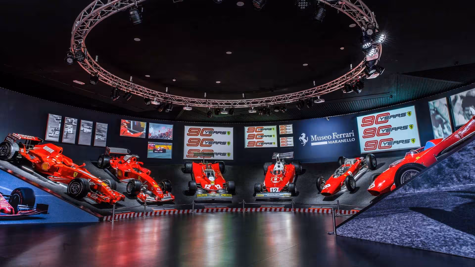 Maranello Ferrari Museum hall with classic red F1 cars, included in Modena museums and Mirabilandia combo ticket