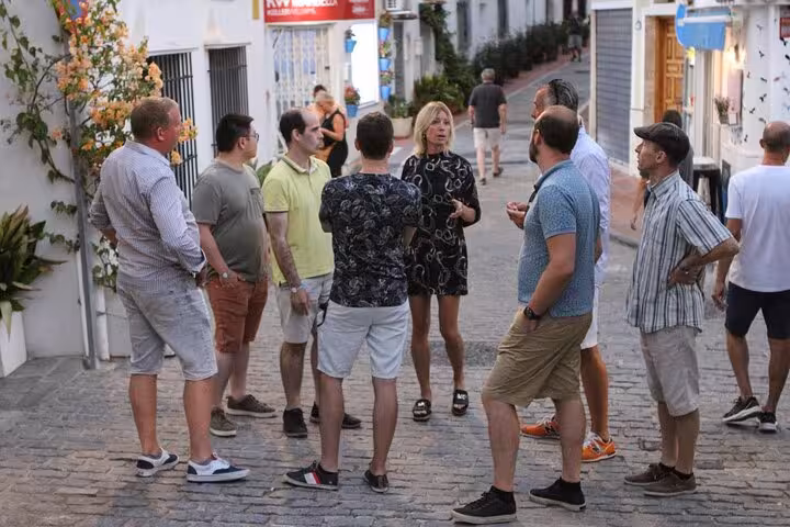 Small group gathered in charming Marbella street for a guided market tour.