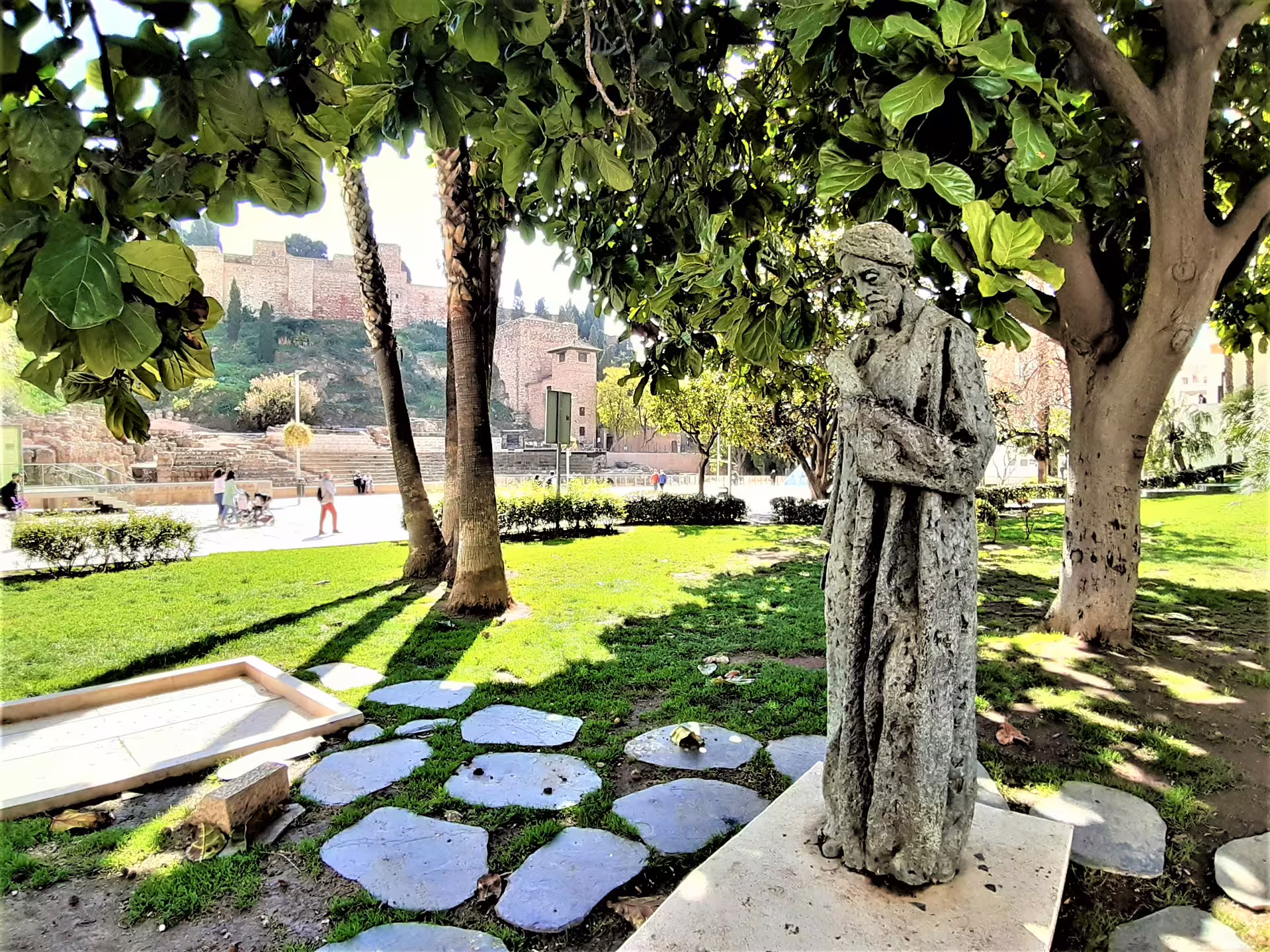 Garden statue with views toward Malaga Alcazaba on a private Marbella to Malaga tour, historic landmarks