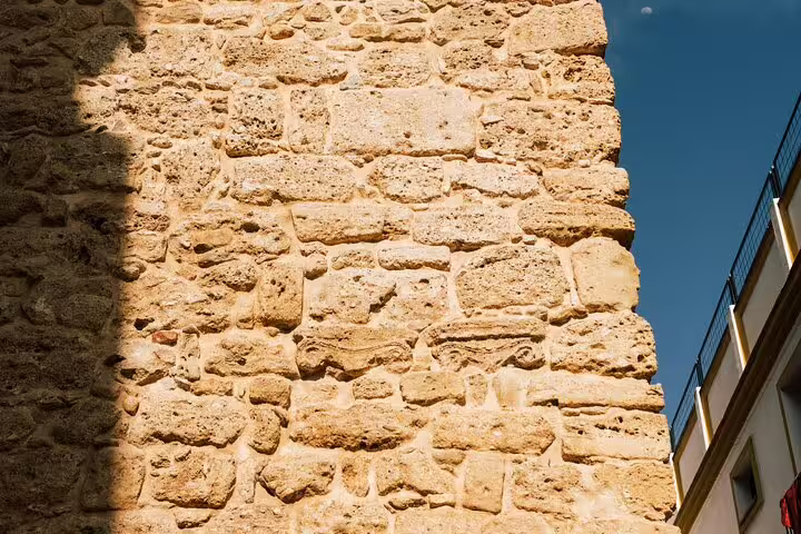 Historic stone wall in Marbella Old Town, showcasing ancient architecture and cultural heritage on a guided tour.