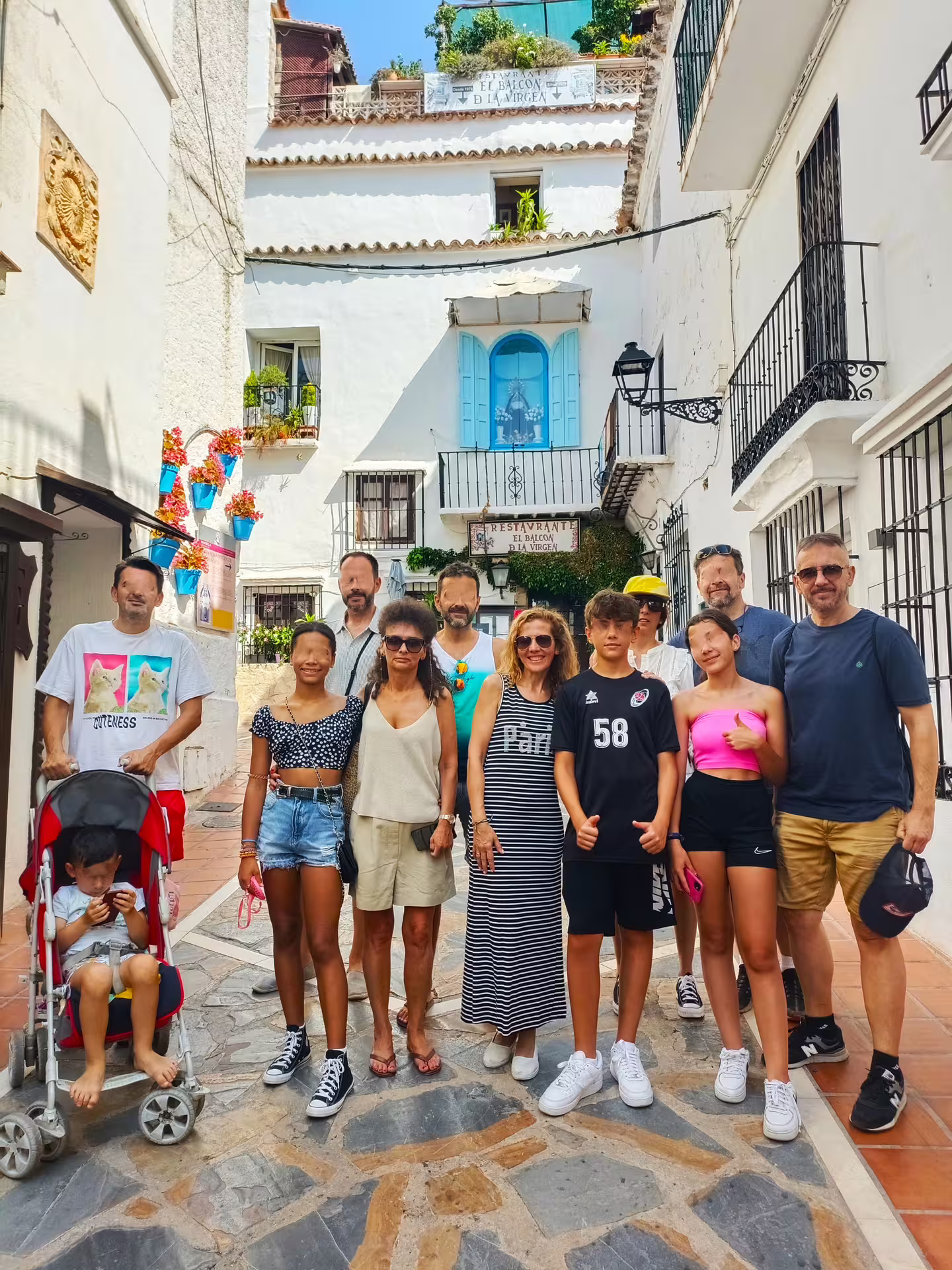 Group photo in Marbella Old Town by whitewashed buildings and blue shutters on a guided walking tour