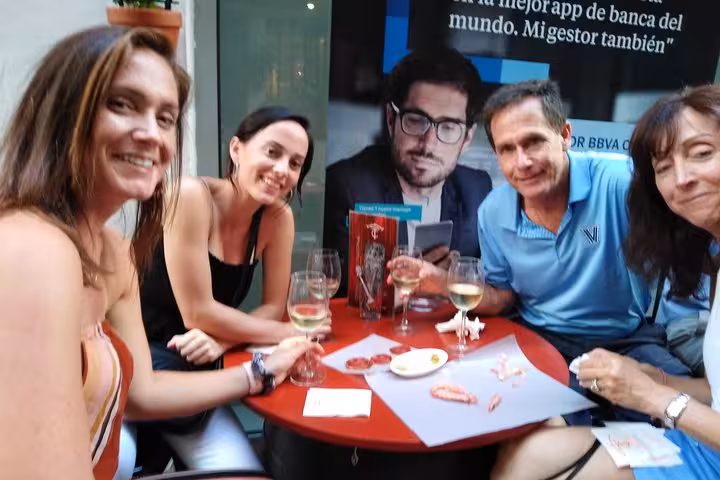 Friends relishing wine and tapas at a charming Marbella cafe during the Original Marbella Tapas Adventure.