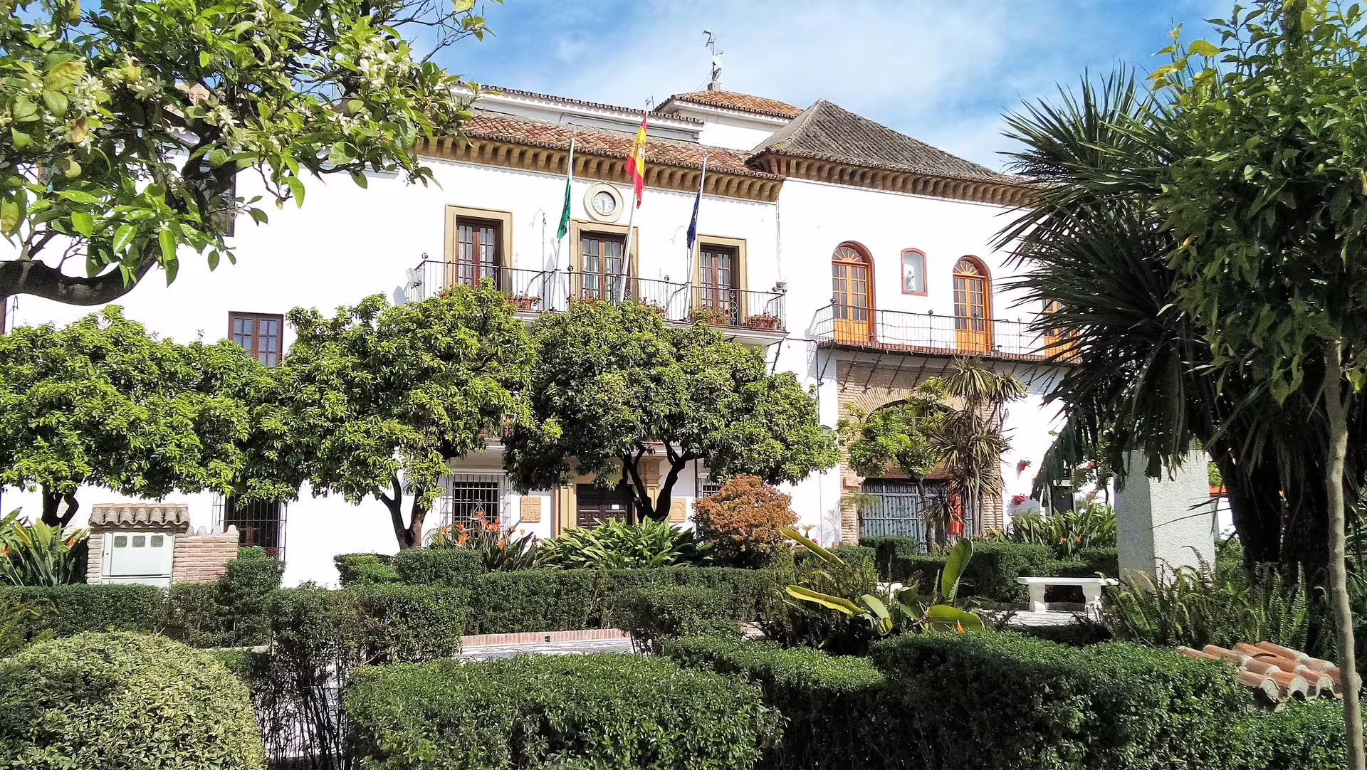 Whitewashed town hall and gardens in Marbella on a private Ronda and Marbella tour with hotel pick-up
