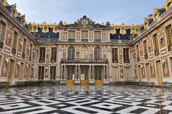 Marble Courtyard at Palace of Versailles with gilded facade, seen on a guided Versailles grand tour