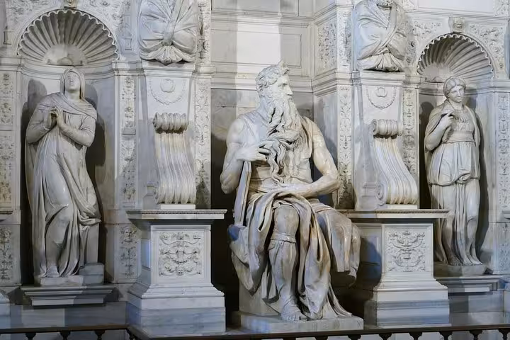 Marble sculptures of religious figures in San Clemente, showcasing intricate artistry on the Underground Rome tour.