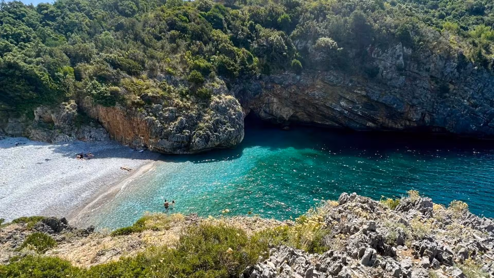 Scenic view of Baia Infreschi's turquoise waters and secluded pebble beach in Marina di Camerota.