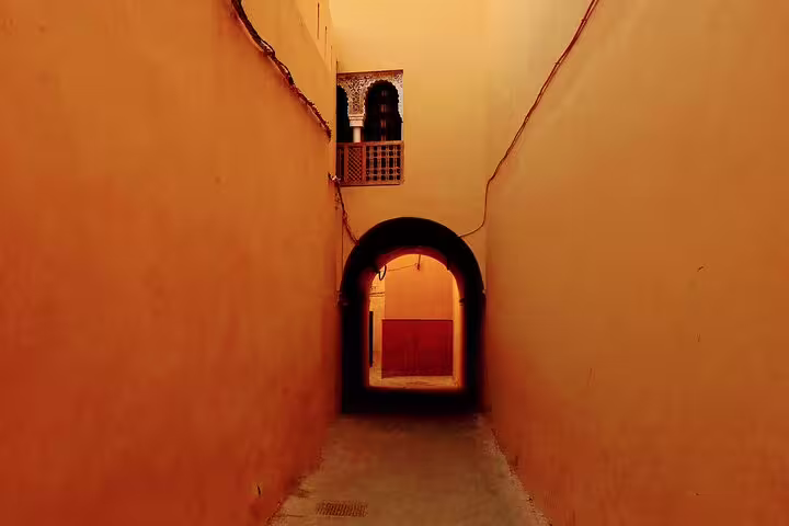 Narrow Marrakech medina alley with arched passage and ochre walls on Mysteries of the Old City walk