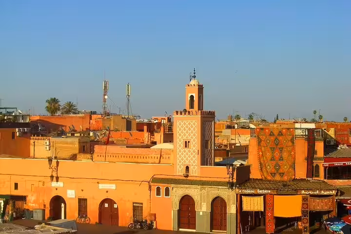 Panoramic view of Marrakech medina rooftops and minaret under blue sky before the Essaouira day tour