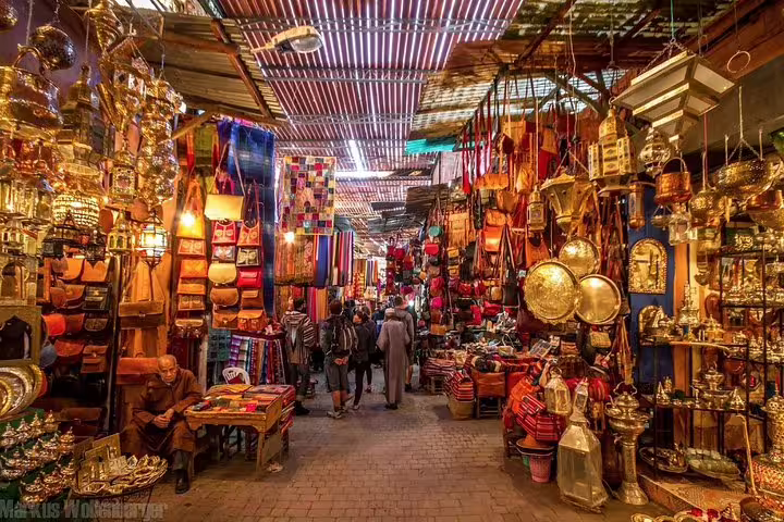 Colorful Marrakech souk market alley with lanterns, leather goods and spices, ideal stop on 9-day Morocco tour