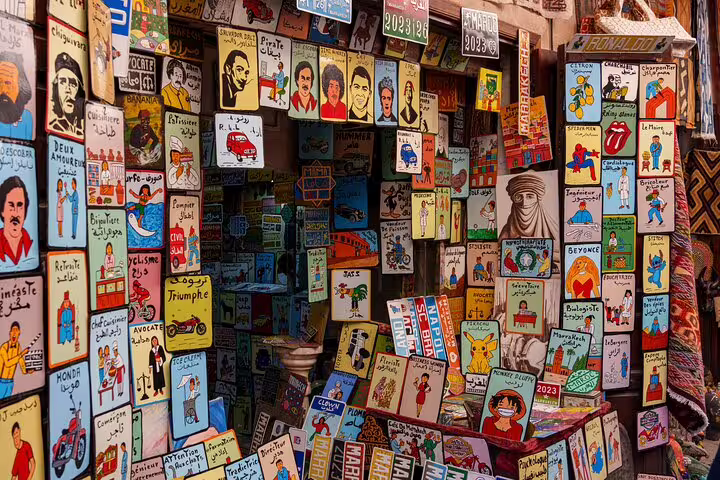 Colorful illustrated postcards and signs in Marrakech souk stall on a half-day local sightseeing tour