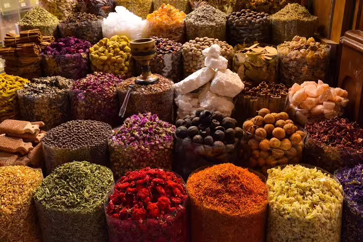 Colorful spice market in Marrakech souk, piles of herbs and saffron on a half-day guided tour with a local