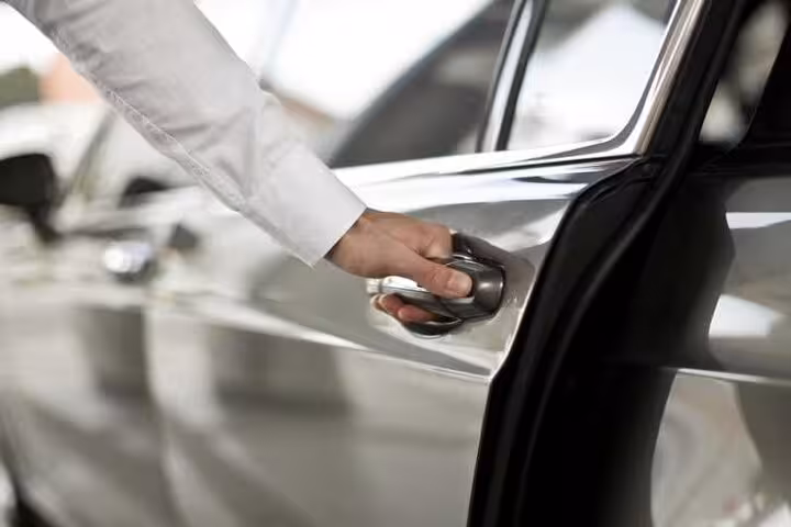 Chauffeur opening car door for exclusive private airport transfer from Marsa Alam with premium meet and greet