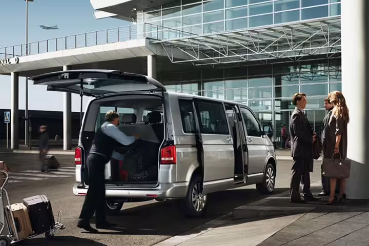 Airport van loading suitcases at terminal for Marsa Alam Airport private transfer service, reliable hotel pickup and drop-off