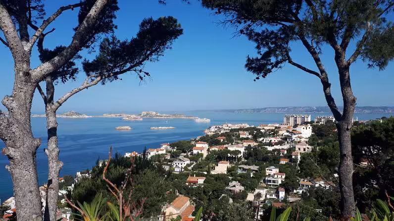 Panoramic Marseille coastline view from Notre-Dame de la Garde hike, Mediterranean sea and islands