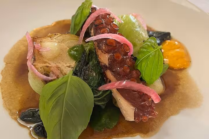 Plated octopus with basil and pickled onions, a Provençal seafood dish from a Marseille cooking workshop