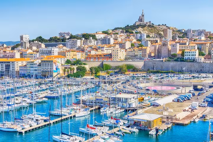 Scenic view of Marseille's Old Port with boats and historic buildings, perfect for a private 2-hour city walk tour.