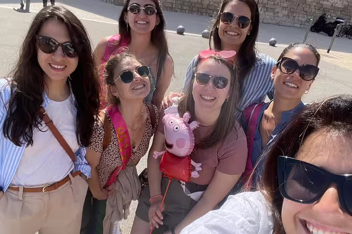 Friends smiling during a Marseille scavenger hunt self-guided tour, exploring city sights in sunny Old Port