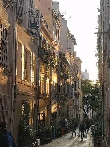 Sunlit narrow Marseille street in Provence, cultural walking stop on 11-day Christian heritage tour