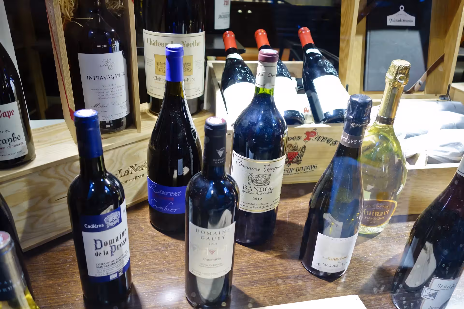 Wine tasting on a Marseille food tour featuring Provence reds and Champagne bottles at a local wine shop