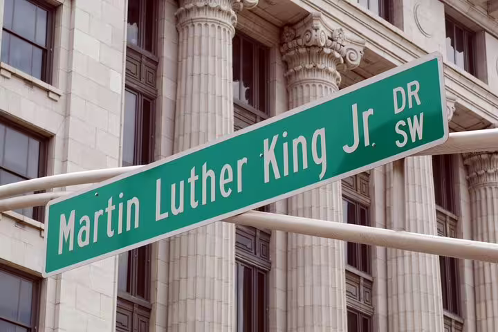 Martin Luther King Jr Drive SW green street sign in Atlanta with classical building columns in background