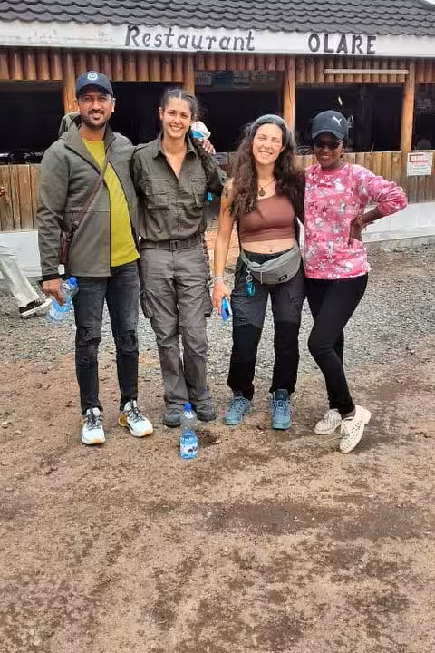 Happy tourists posing outside Olare restaurant during a memorable Masai Mara safari trip.