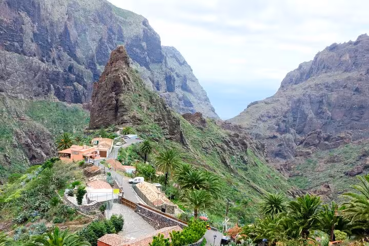 Breathtaking view of Masca village nestled in stunning Tenerife mountains, ideal for cultural and culinary exploration.