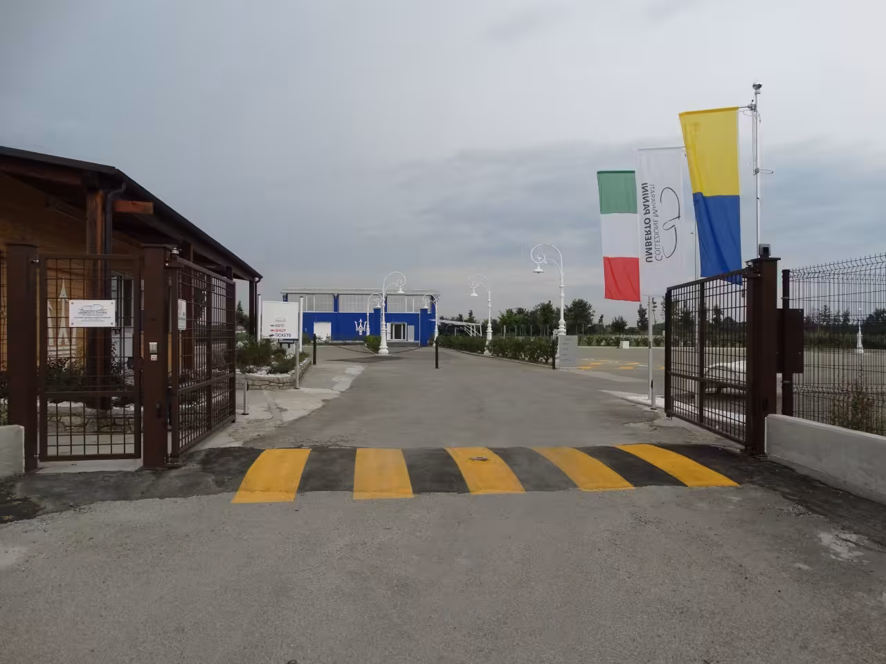 Entrance gate with flags leading to Maserati Umberto Panini Collection in Modena for museum ticket holders