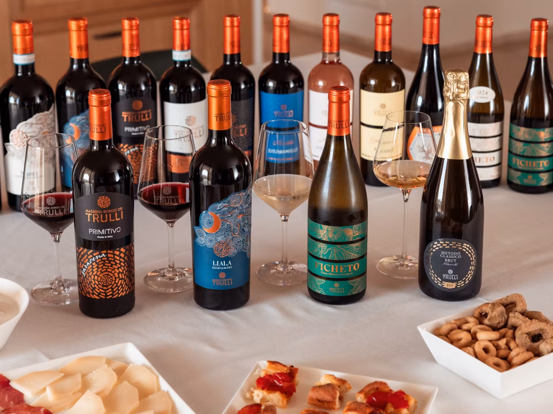 Selection of wines and appetizers at a Masseria winery near Taranto, showcasing a premium tasting experience.