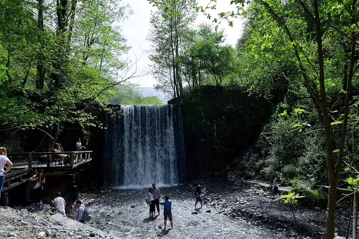Maşukiye waterfall in lush woodland with visitors on viewing platform, highlight of private Sapanca day trip