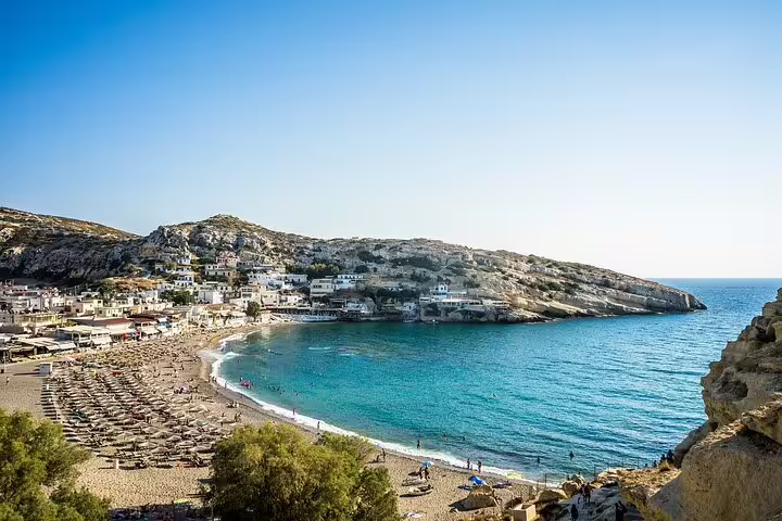 Relax on the picturesque beach of Matala, Crete, with its vibrant village and stunning coastal views.