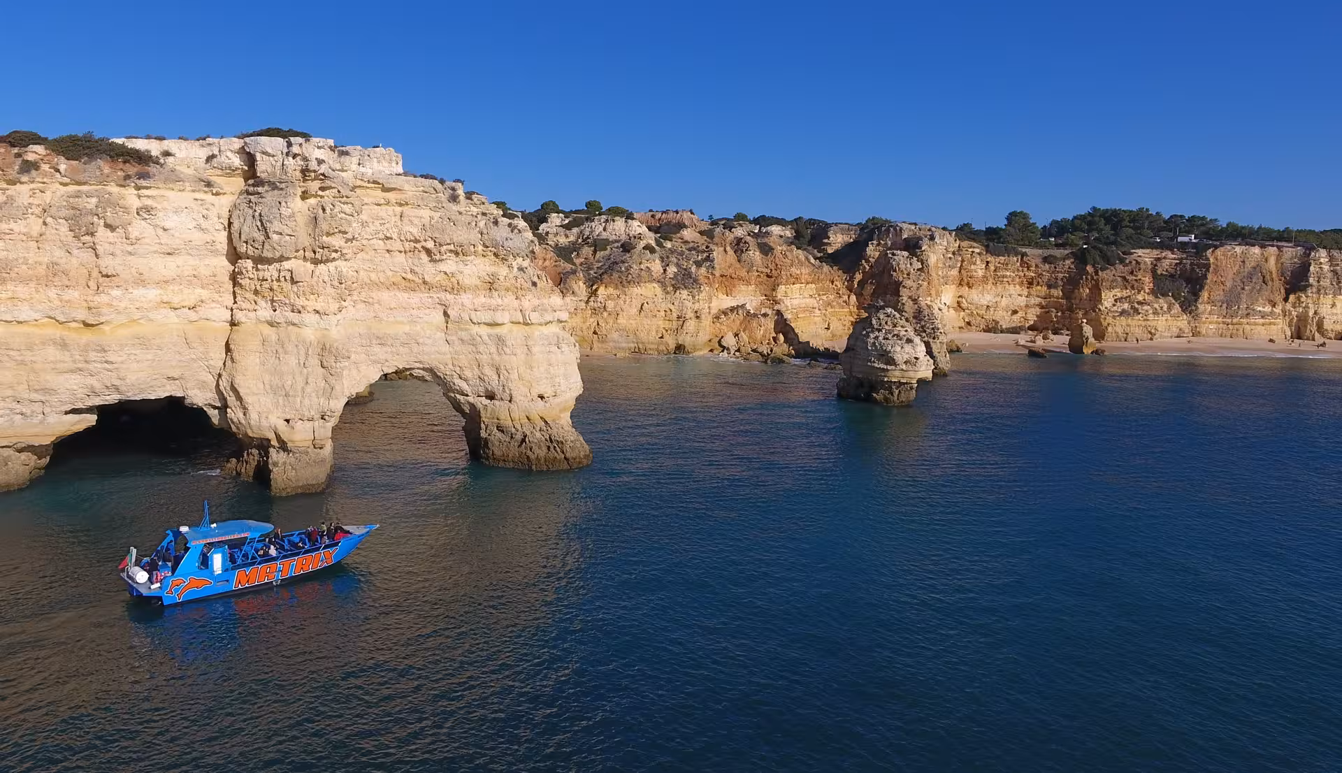Explore stunning coastal caves by boat on the MATRIX tour, offering a unique Algarve adventure with breathtaking views.
