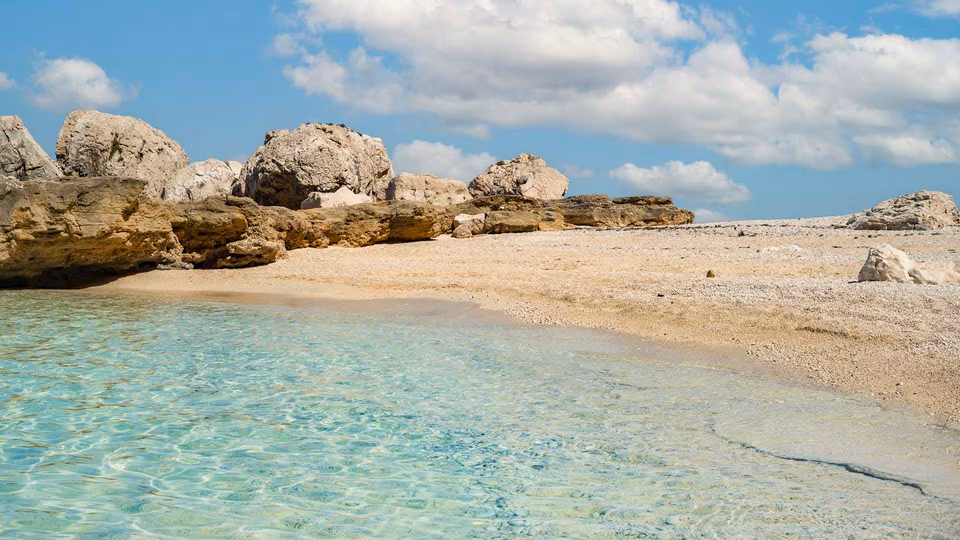 Relax on the serene sandy beach with crystal-clear waters on a dinghy tour in the Gulf of Orosei from Santa Maria Navarrese.