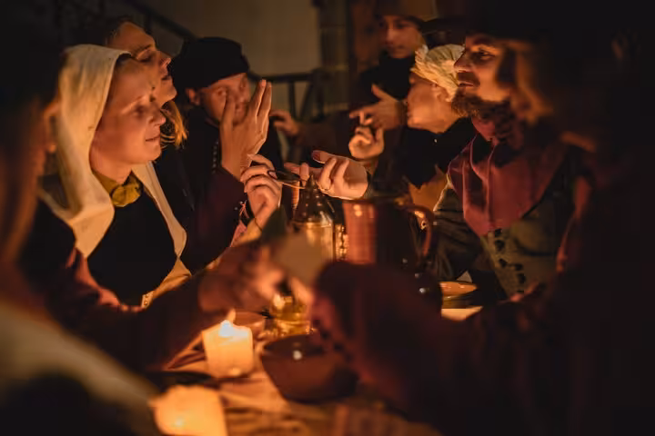 Medieval candlelit tavern scene featured in Tales of Reval self-guided GPS walking tour app in Tallinn
