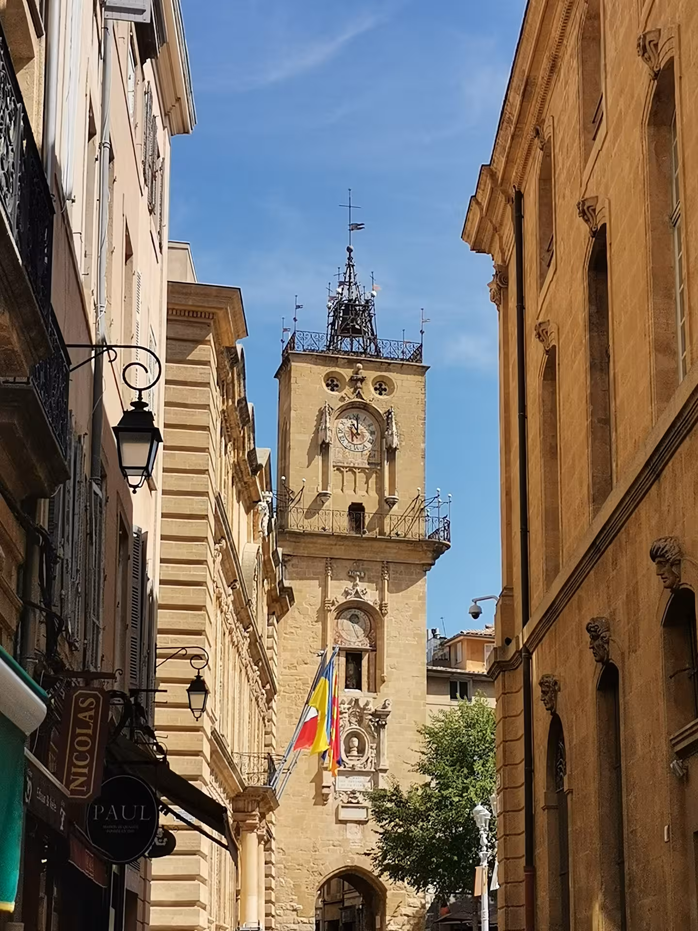Medieval clock tower in a Provence old town street, a cultural stop on the 14-day Christian heritage tour