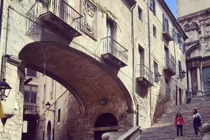 Walk through historic stone arches and steps on the Three Medieval Gems tour, capturing the essence of ancient architecture.