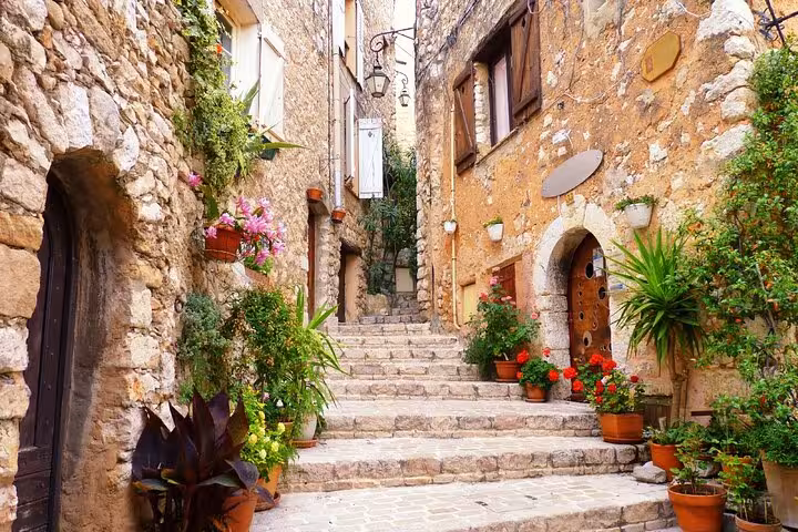 Charming flower-lined stone stairway in a medieval Provence village on a private tour of southern France