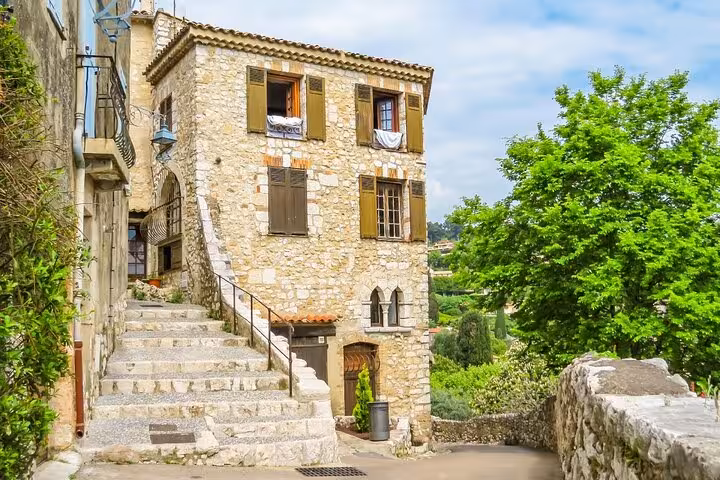 Historic stone building with wooden shutters and steep staircase in a picturesque medieval village of Provence France