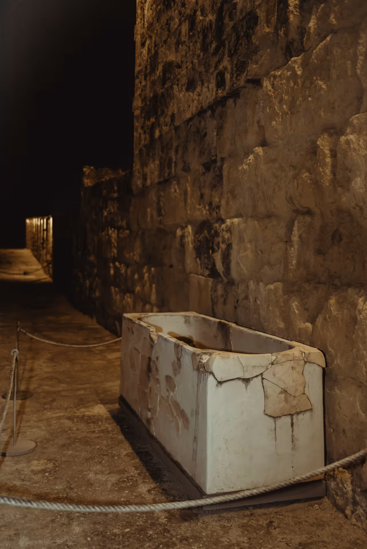 Ancient stone pathway and relics illuminated during a night tour of Medina Azahara.