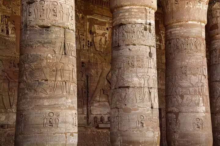 Carved hieroglyphs on massive columns inside Medinet Habu Temple, Luxor, on Dendera day trip