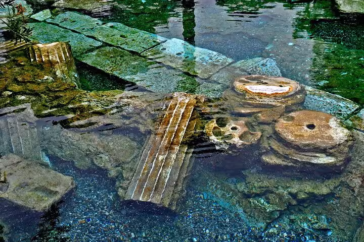 Sunken ancient ruins in clear turquoise water, a scenic stop on the 8 Day Touch of Mediterranean Tour