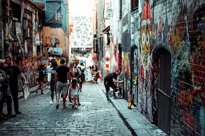 Visitors walking through Melbourne's Hosier Lane covered in colorful graffiti and street art murals