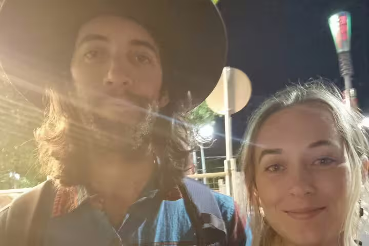 Couple taking a selfie at night during Melbourne walking tour