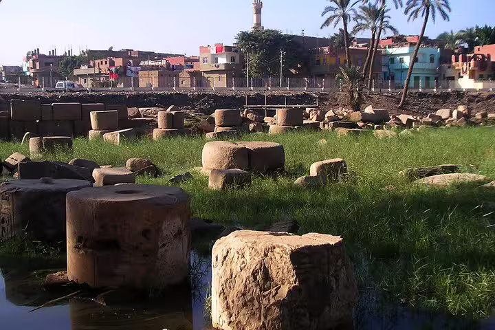 Memphis ruins and ancient stone blocks near Nile fields, stop on Cairo layover tour to Saqqara and Dahshur