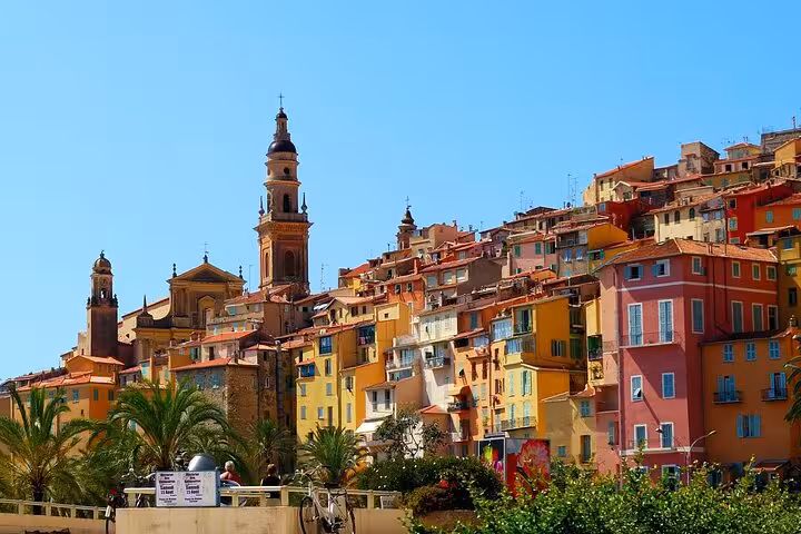 Colorful buildings and church tower on hillside in Menton, French Riviera