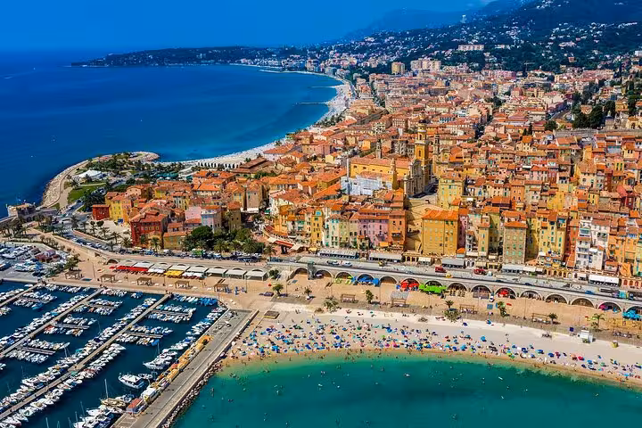 Aerial view of Menton's colorful coastline and vibrant marina on the French Riviera, ideal for a private tour.