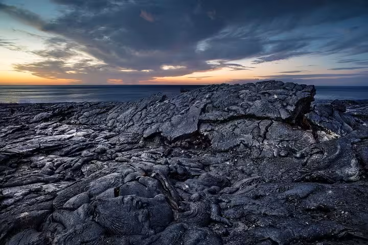Hardened black lava fields at sunset near volcanic coastline in Iceland